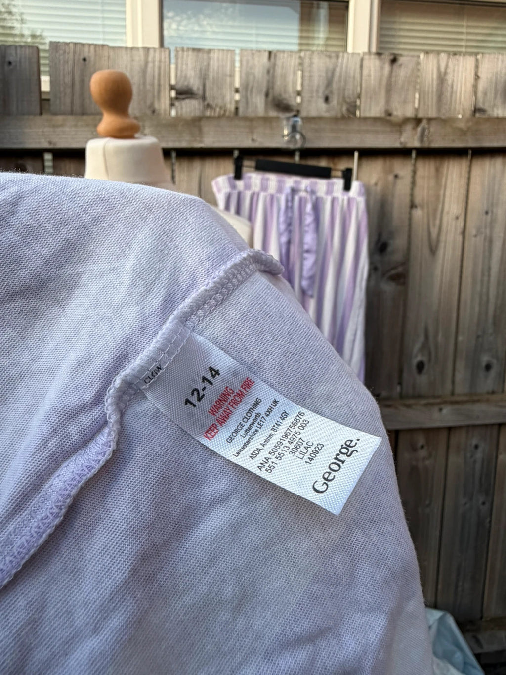 George lilac and white striped pyjama set with button-up shirt and wide leg trousers.
