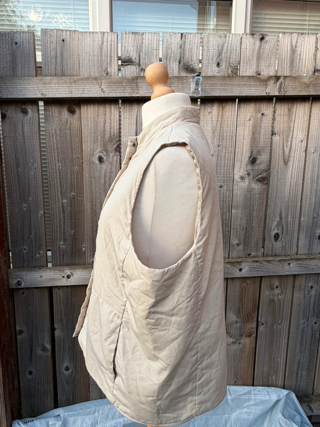 BHS beige padded puffer gilet sleeveless jacket with minimalist design and neutral tones.