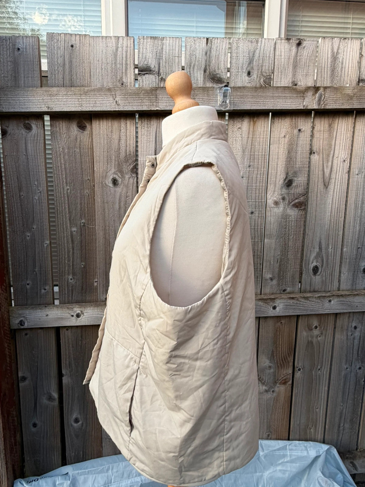 BHS beige padded puffer gilet sleeveless jacket with minimalist design and neutral tones.