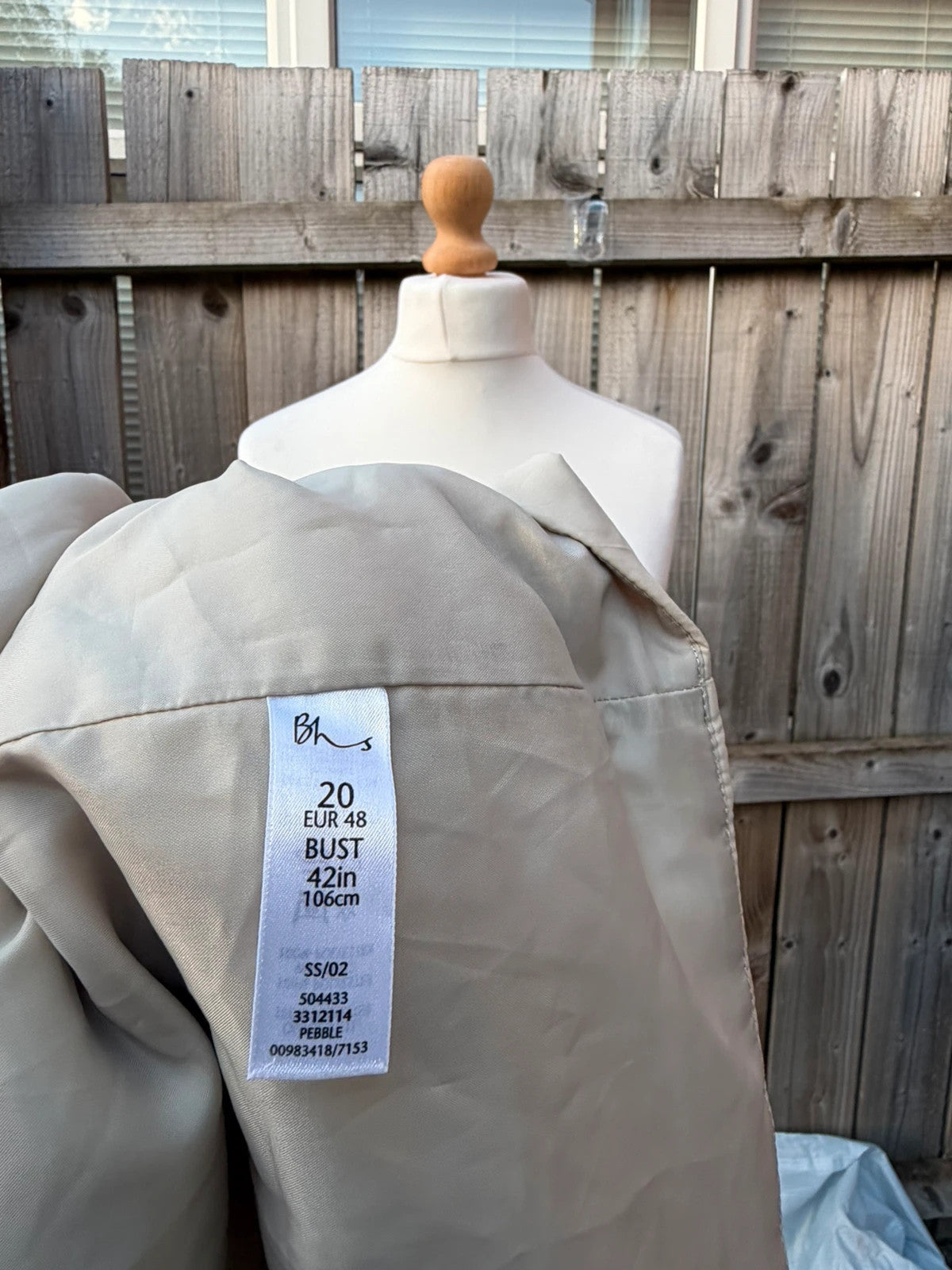 BHS beige padded puffer gilet sleeveless jacket with minimalist design and neutral tones.
