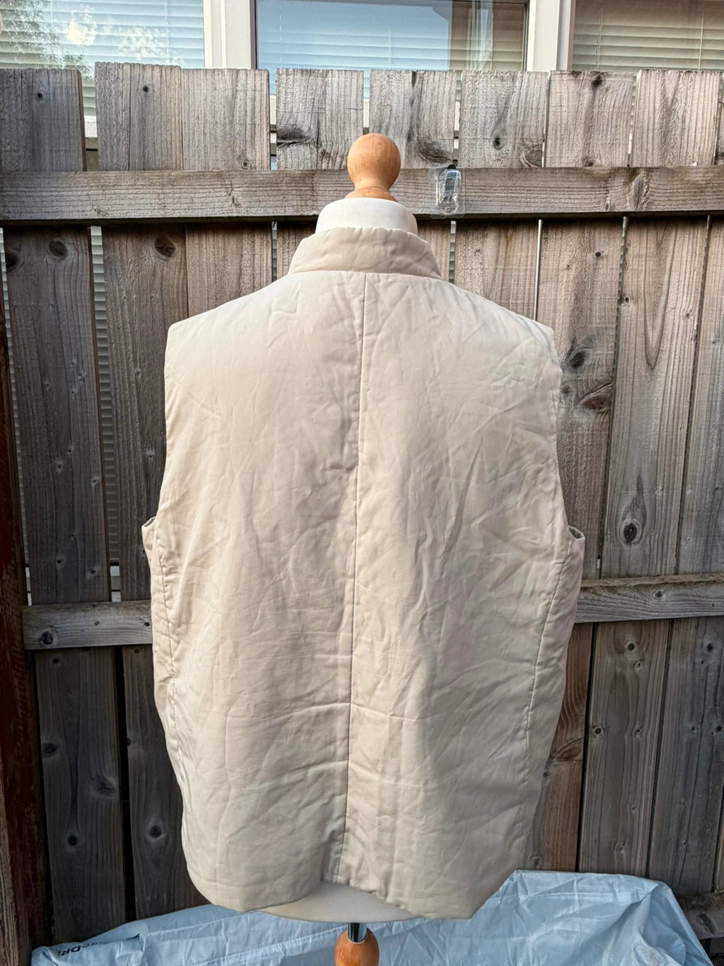 BHS beige padded puffer gilet sleeveless jacket with minimalist design and neutral tones.