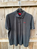 Hugo Boss black polo shirt with red logo, classic fit, premium cotton material.