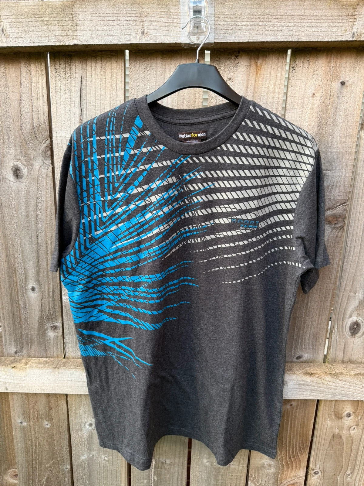 Atlas for Men blue and grey graphic t-shirt with athletic design and logo.