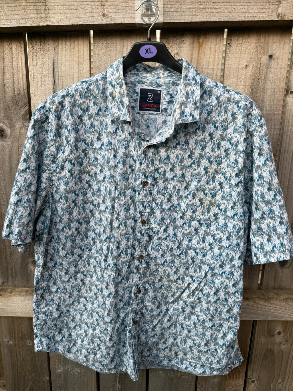 Casuals blue graphic tee with abstract pattern and button-up front, preloved condition.