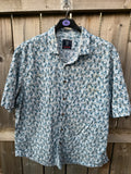 Casuals blue graphic tee with abstract pattern and button-up front, preloved condition.
