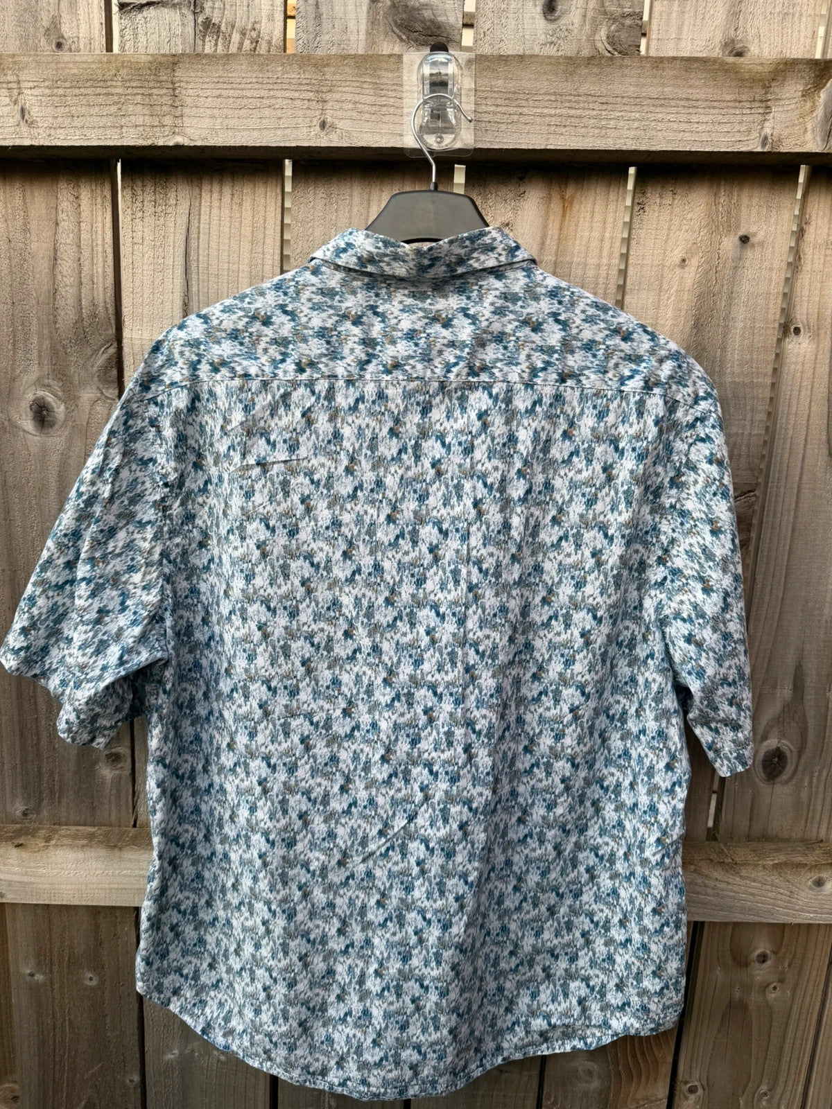 Casuals blue graphic tee with abstract pattern and button-up front, preloved condition.