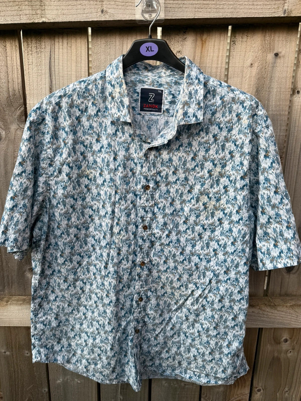 Casuals blue graphic tee with abstract pattern and button-up front, preloved condition.
