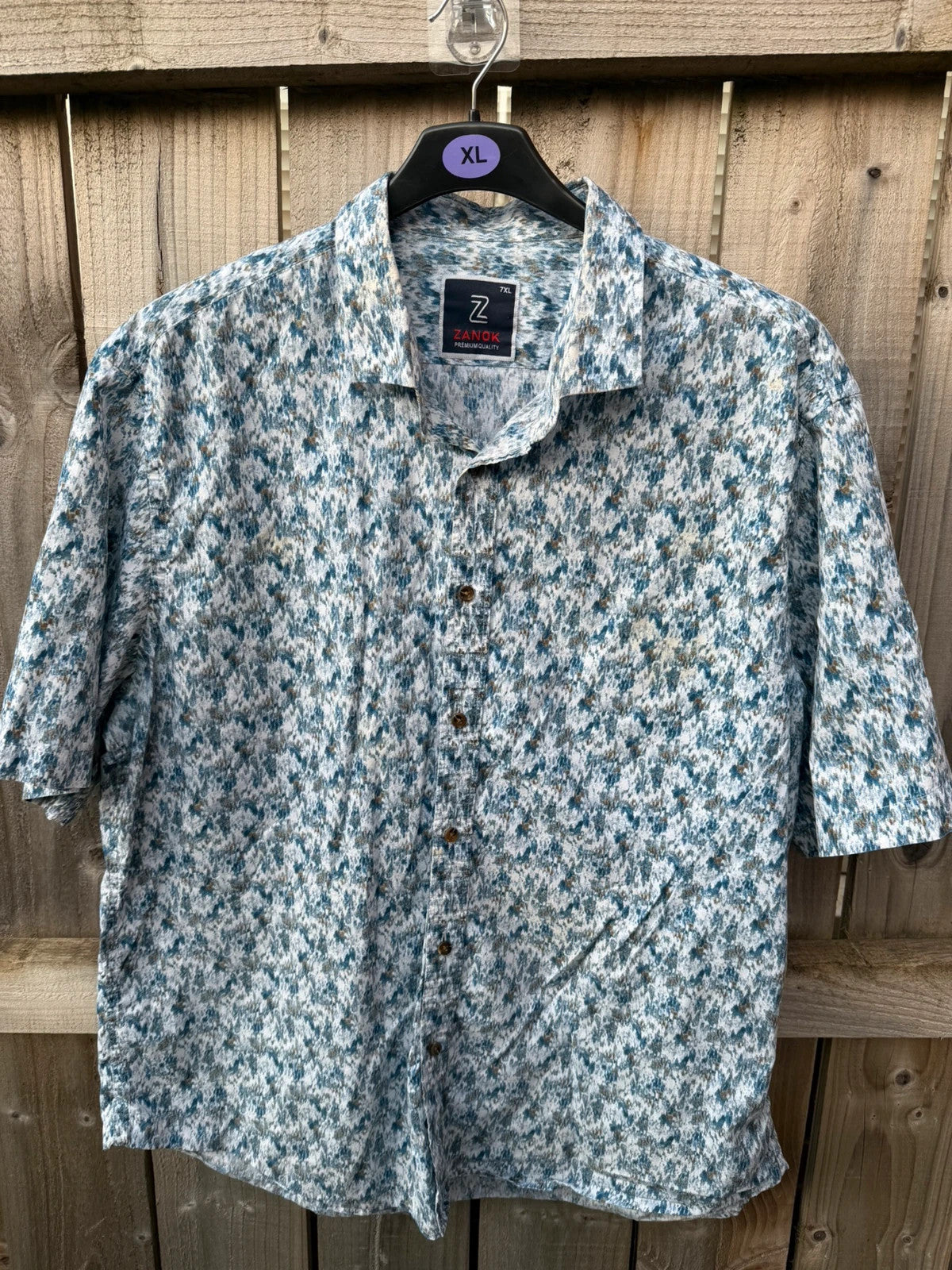 Casuals blue graphic tee with abstract pattern and button-up front, preloved condition.