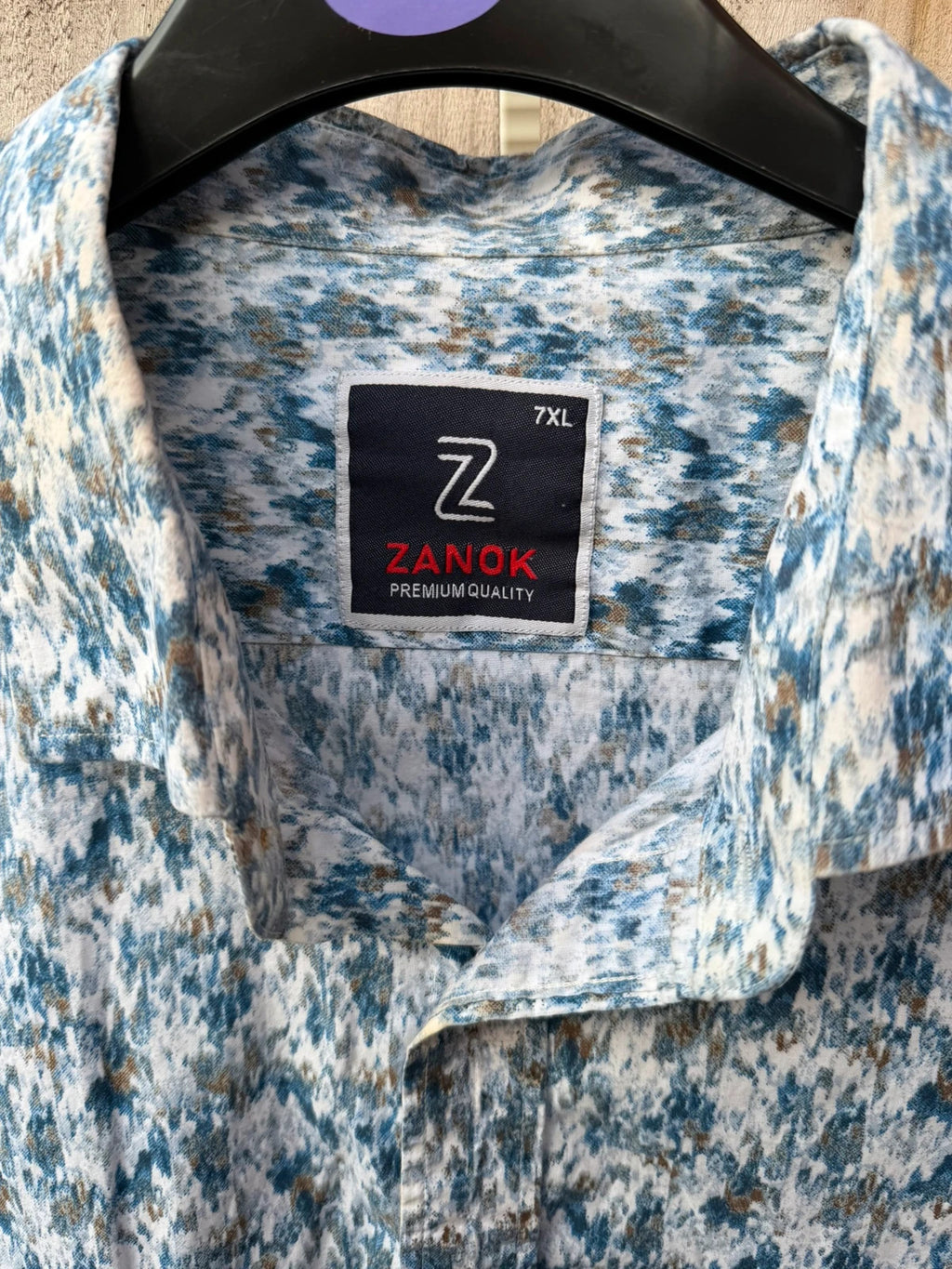 Casuals blue graphic tee with abstract pattern and button-up front, preloved condition.
