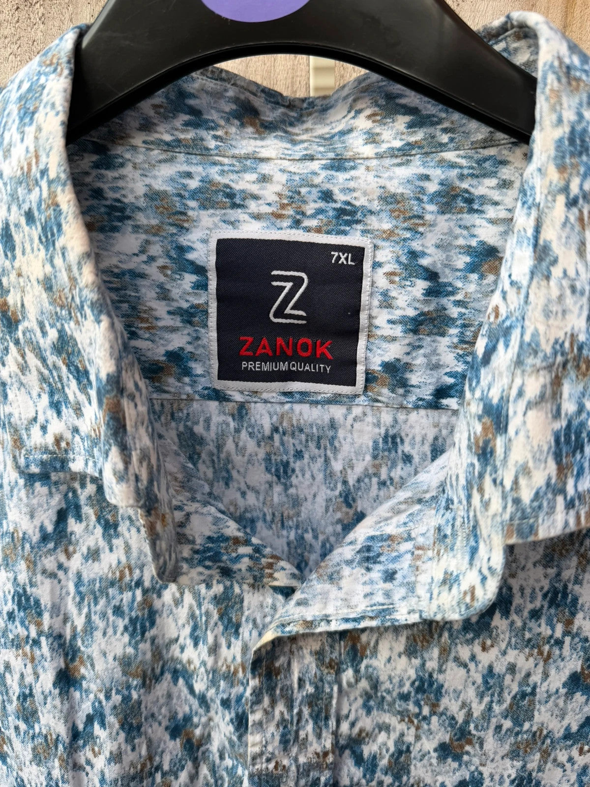 Casuals blue graphic tee with abstract pattern and button-up front, preloved condition.