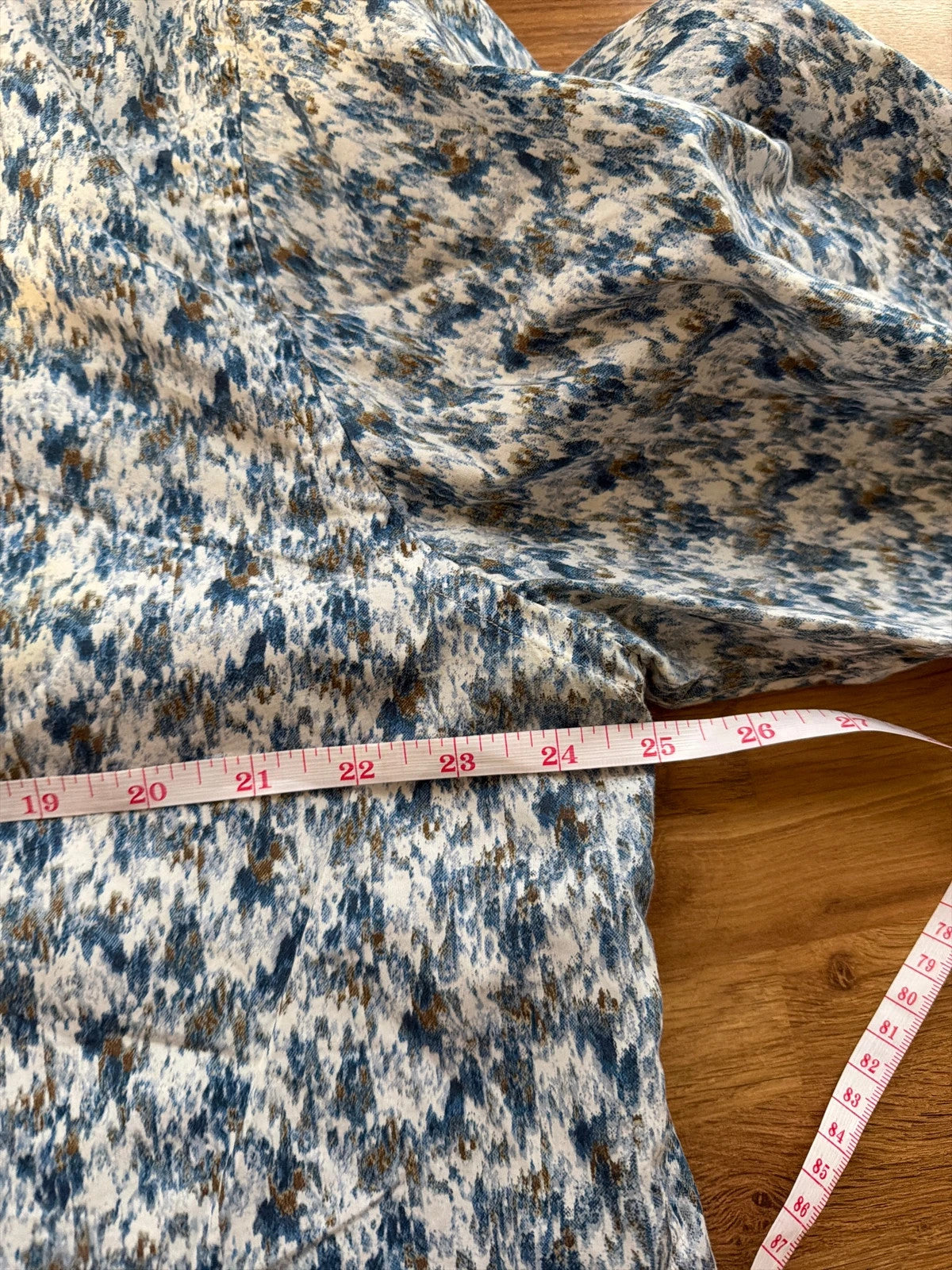 Casuals blue graphic tee with abstract pattern and button-up front, preloved condition.