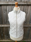 LOFT white sleeveless puffer vest with zip closure and lightweight material.
