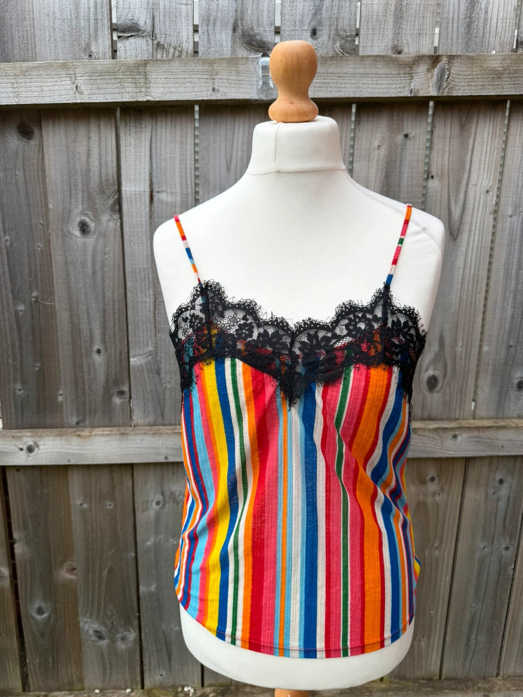 Zara multi-coloured striped sleeveless vest with vibrant Y2K festival style.