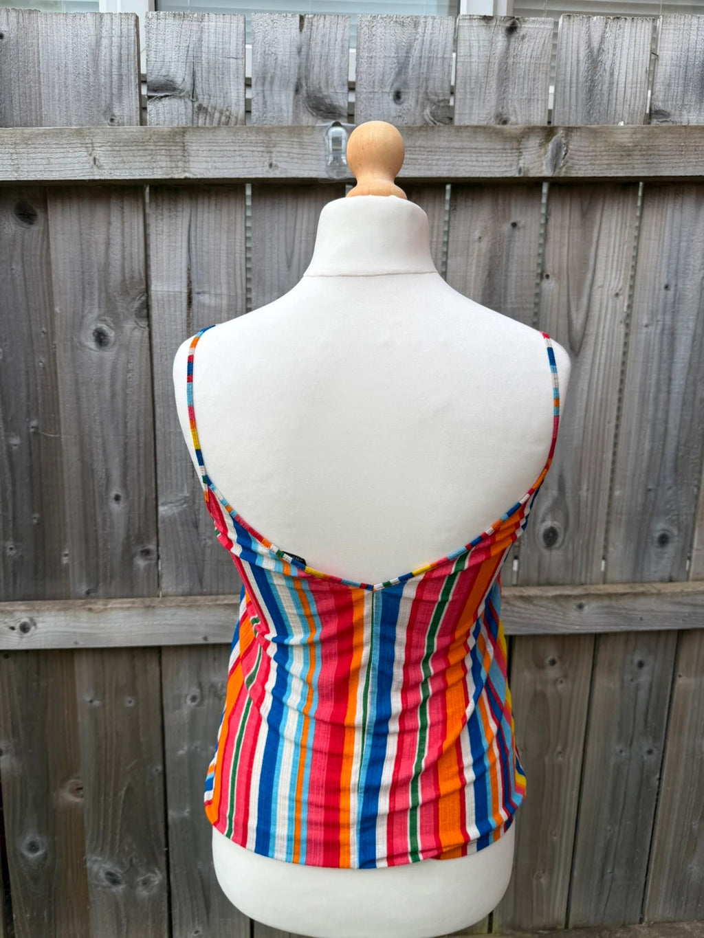 Zara multi-coloured striped sleeveless vest with vibrant Y2K festival style.