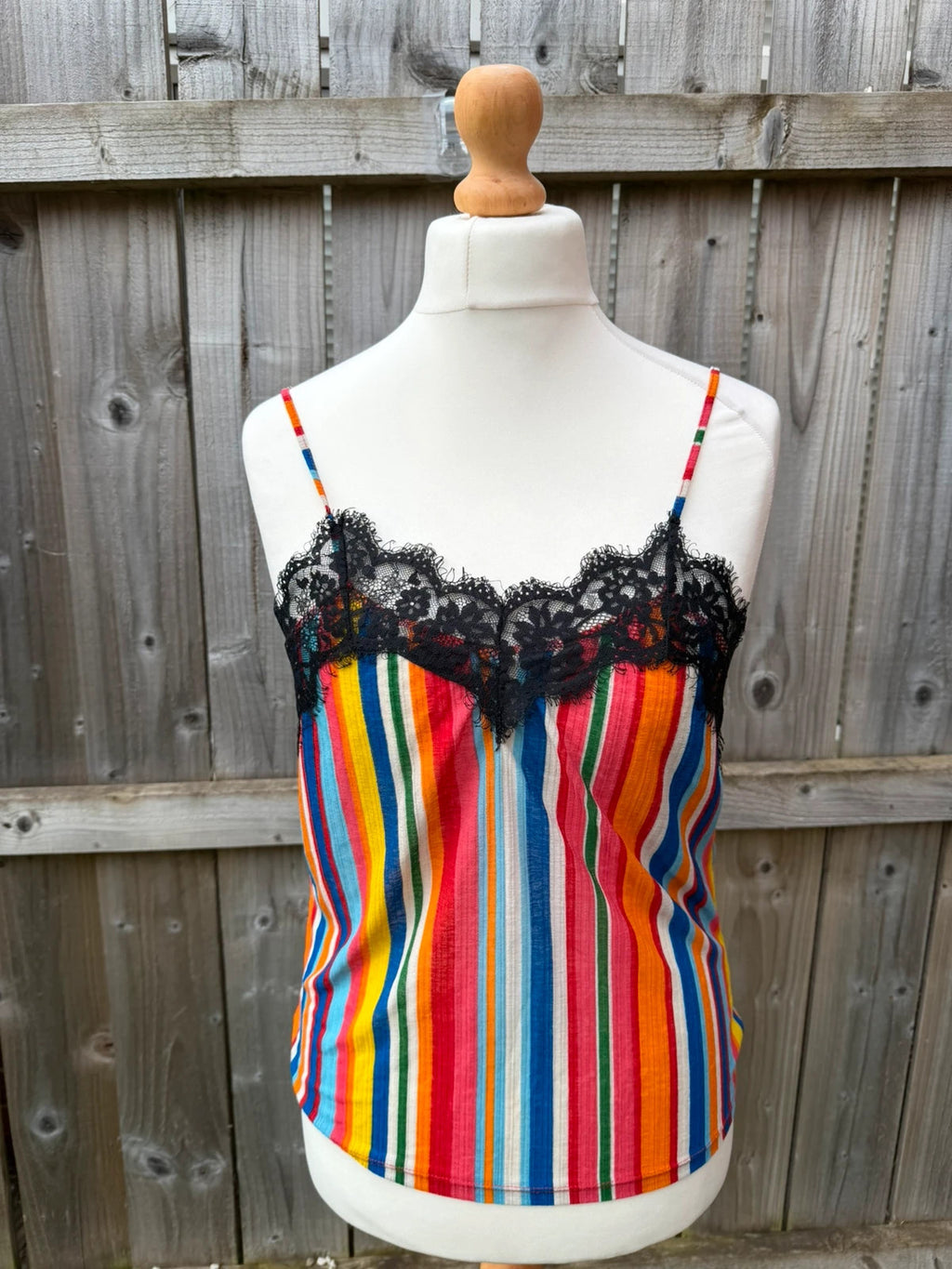 Zara multi-coloured striped sleeveless vest with vibrant Y2K festival style.