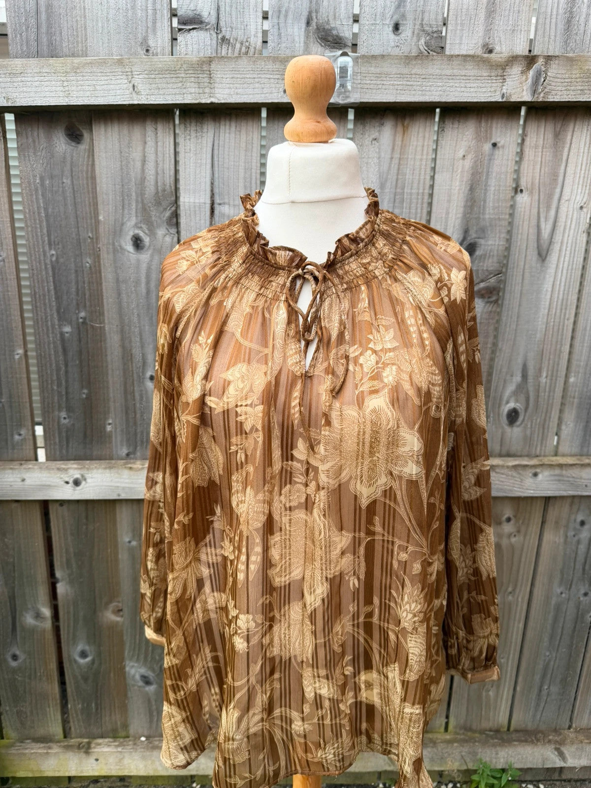 Casuals black and brown floral sheer long sleeve tunic blouses, smart casual style.