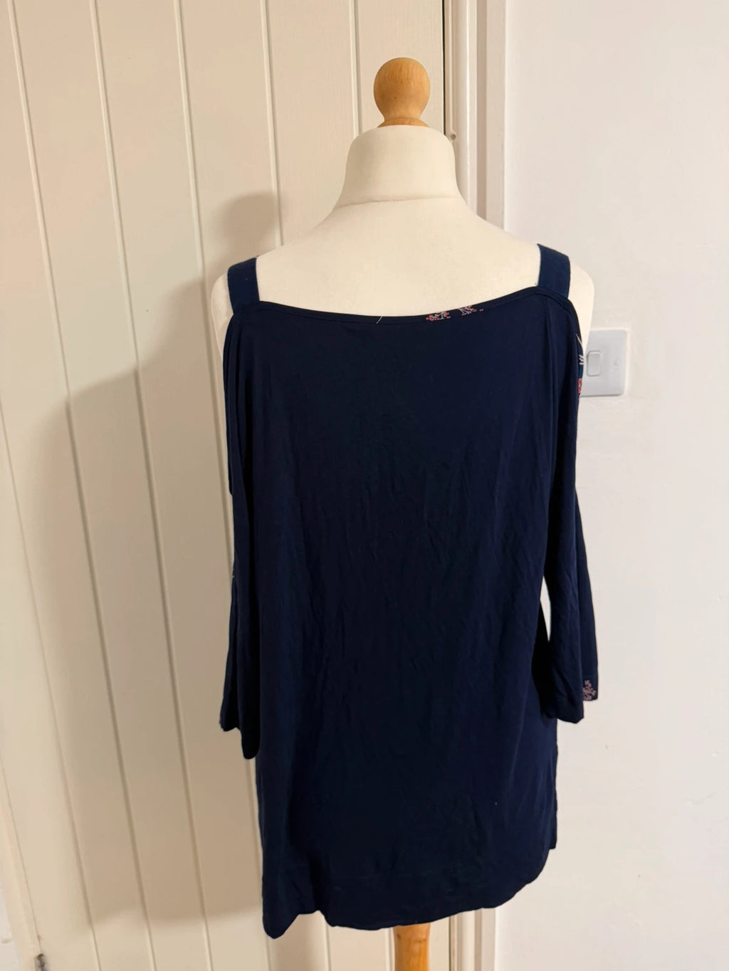 Marks & Spencer navy cold shoulder dress with floral pattern and elegant design.