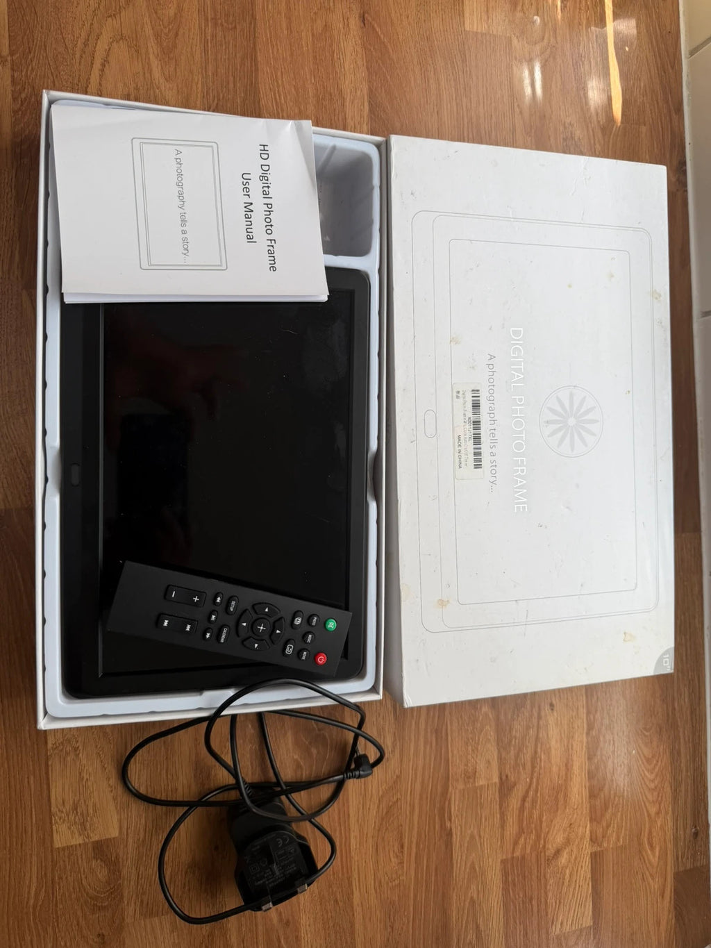 Universal black digital photo frame with remote, sleek design, pre-loved condition.