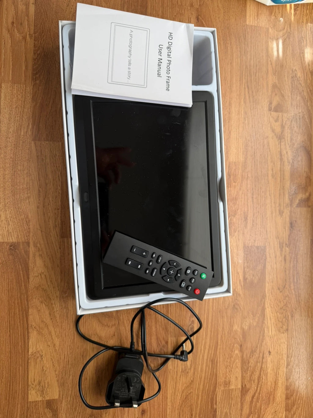 Universal black digital photo frame with remote, sleek design, pre-loved condition.