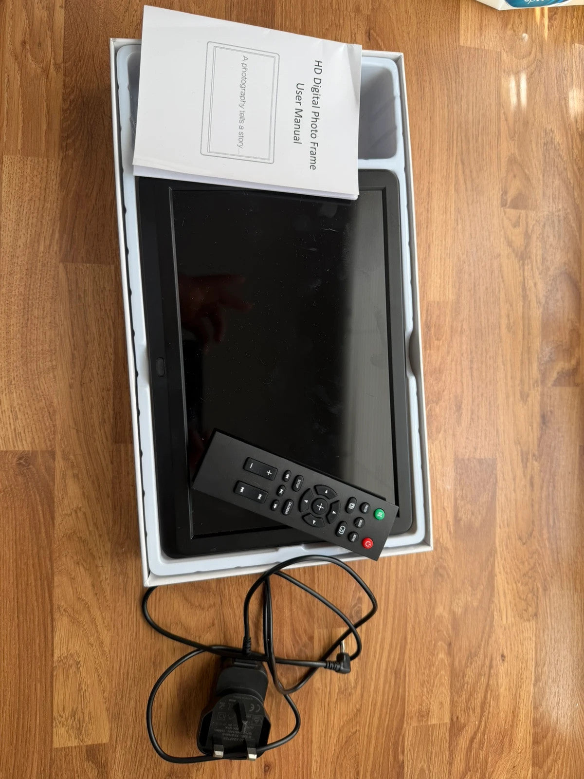 Universal black digital photo frame with remote, sleek design, pre-loved condition.