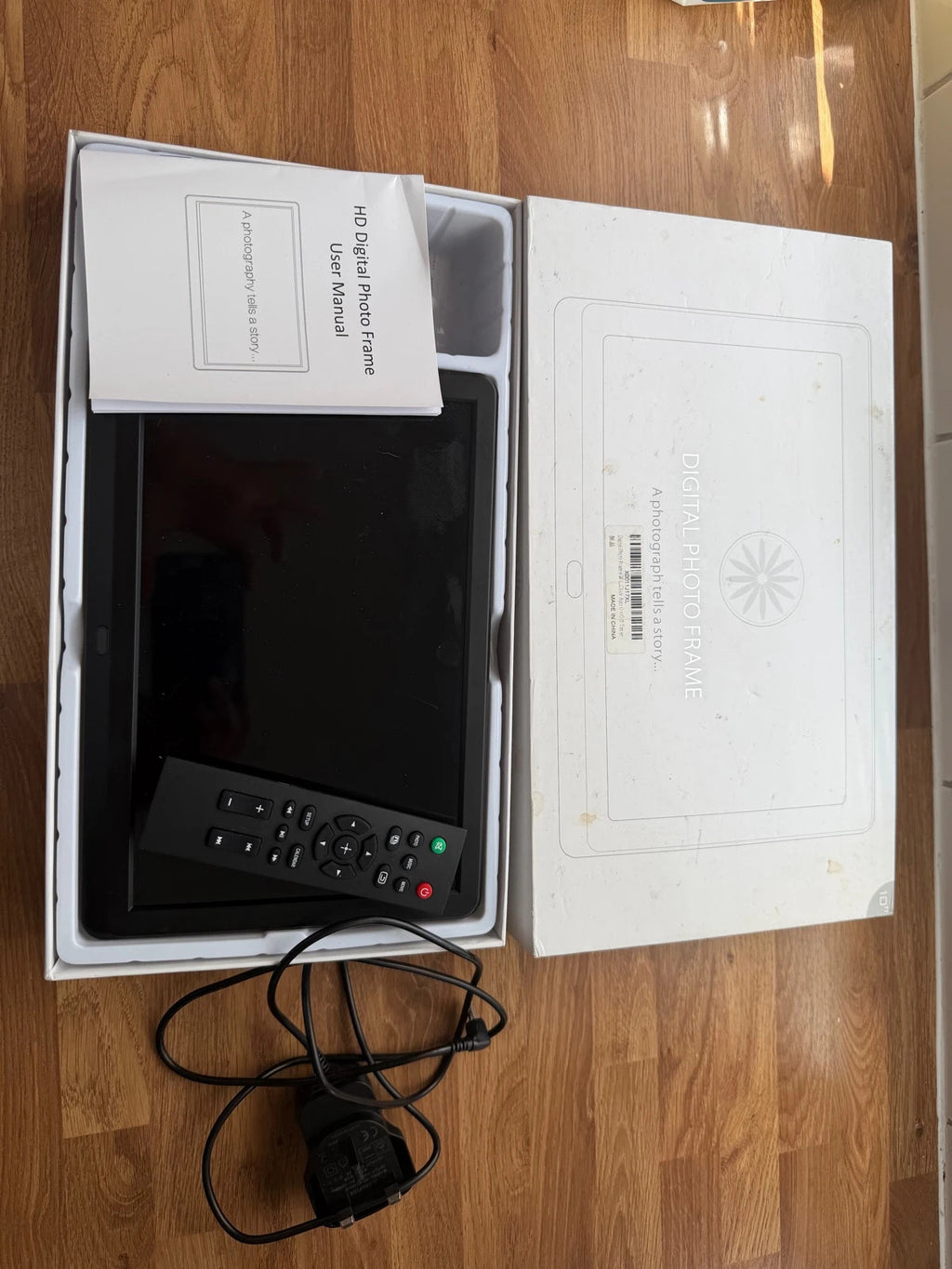 Universal black digital photo frame with remote, sleek design, pre-loved condition.