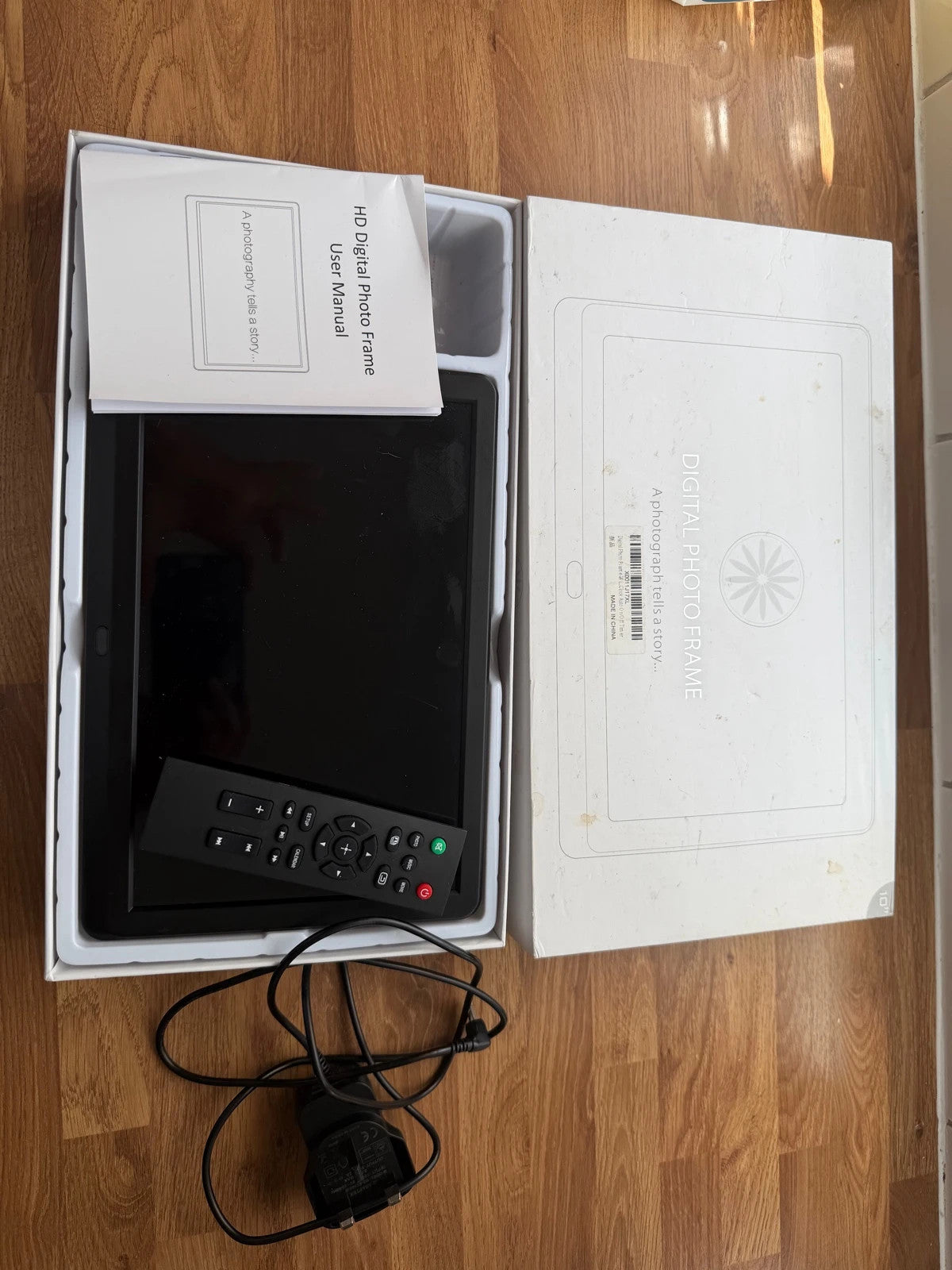 Universal black digital photo frame with remote, sleek design, pre-loved condition.