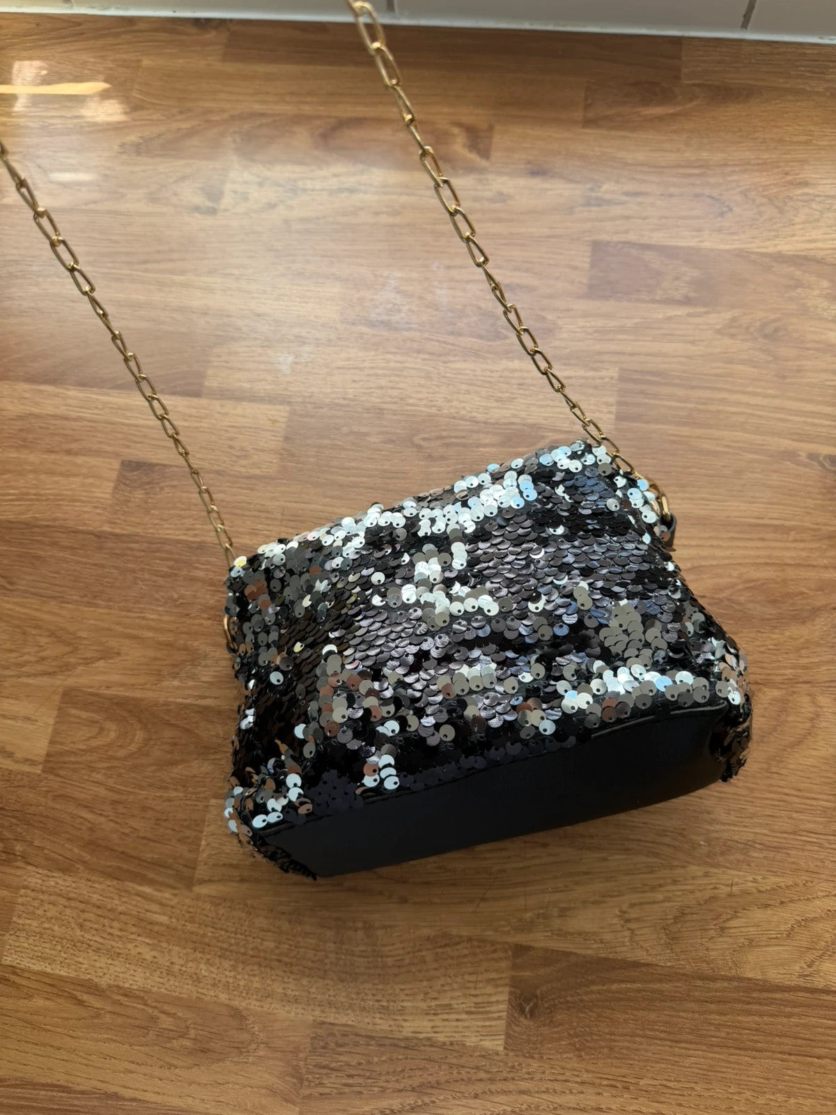 Accessories black sequin shoulder bag with silver accents and glamorous evening style.
