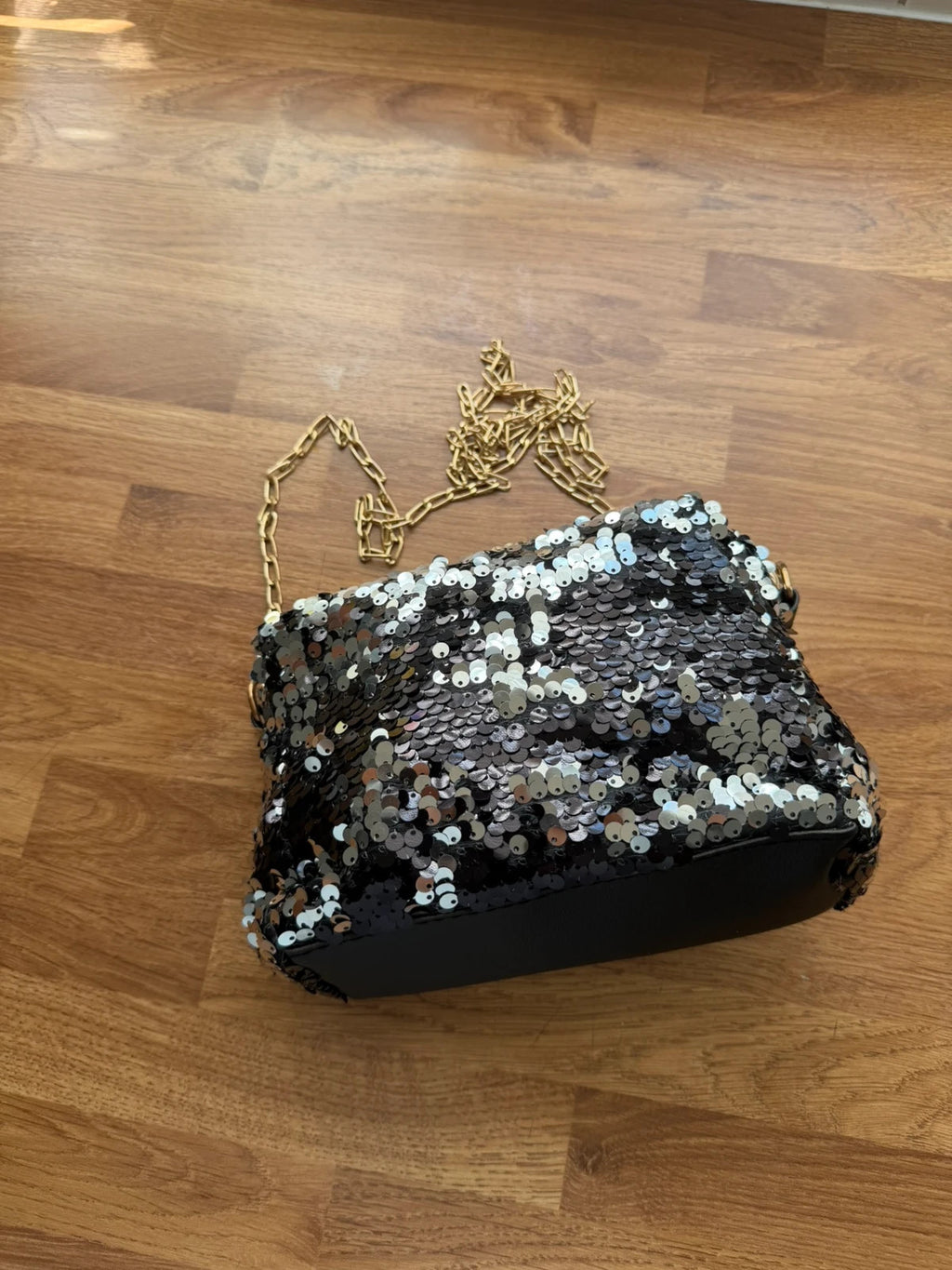 Accessories black sequin shoulder bag with silver accents and glamorous evening style.