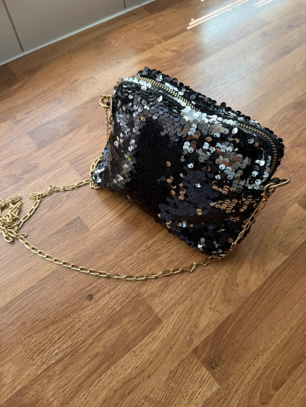 Accessories black sequin shoulder bag with silver accents and glamorous evening style.