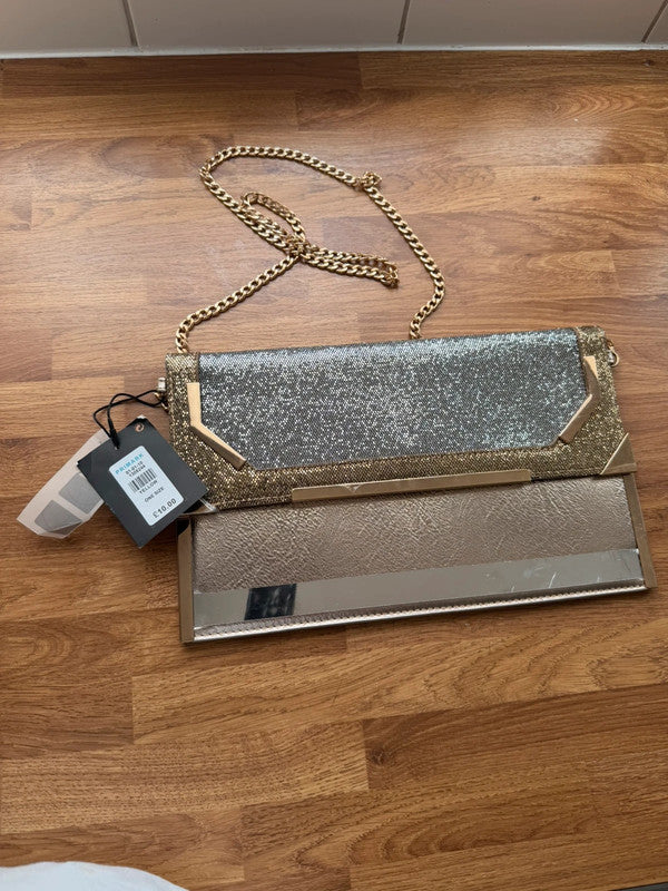 Primark gold clutch bag with glitter finish and new with tags.