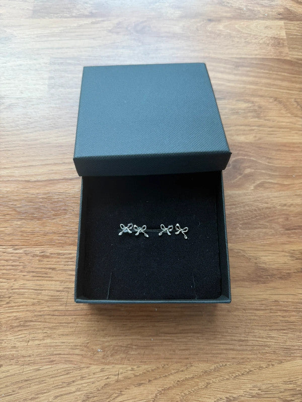 Accessories silver stud earrings with cute bow design, minimalist and elegant style.