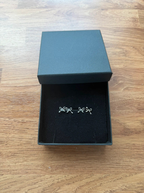 Accessories silver stud earrings with cute bow design, minimalist and elegant style.