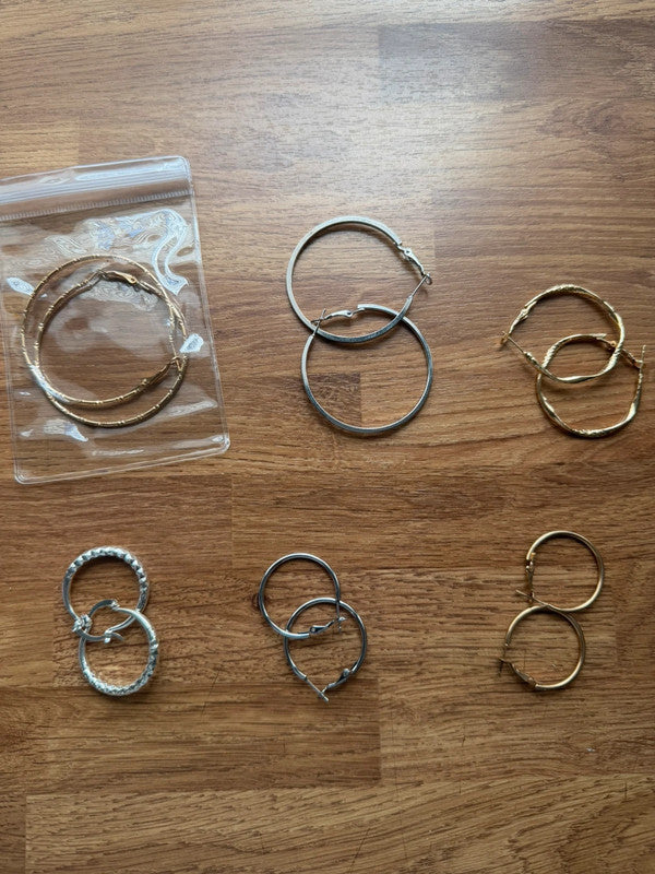 Y2K gold and silver large hoop earrings with shiny finish and statement design.
