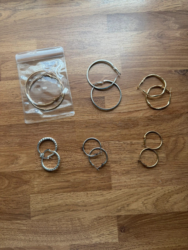 Y2K gold and silver large hoop earrings with shiny finish and statement design.