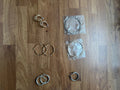 Y2K gold and silver large hoop earrings set with shiny metallic finish.