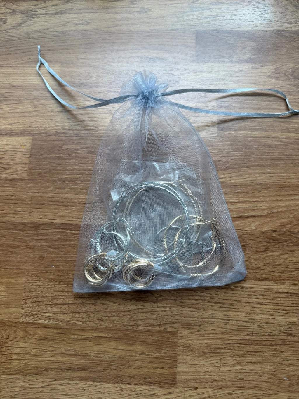 Y2K gold and silver large hoop earrings set with shiny metallic finish.