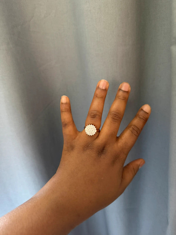 Cartier gold statement ring with diamond accents and intricate design details.