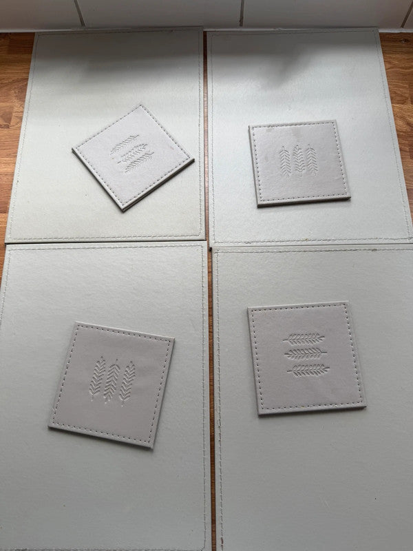 Faux grey faux leather placemats with matching coasters, pre-loved condition.