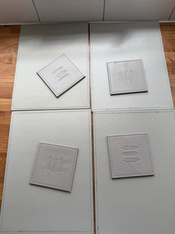 Faux grey faux leather placemats with matching coasters, pre-loved condition.