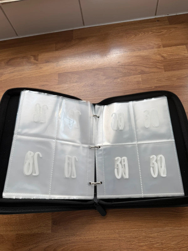 Cash's black budget planner with cash stuffing compartments and organizer pockets.