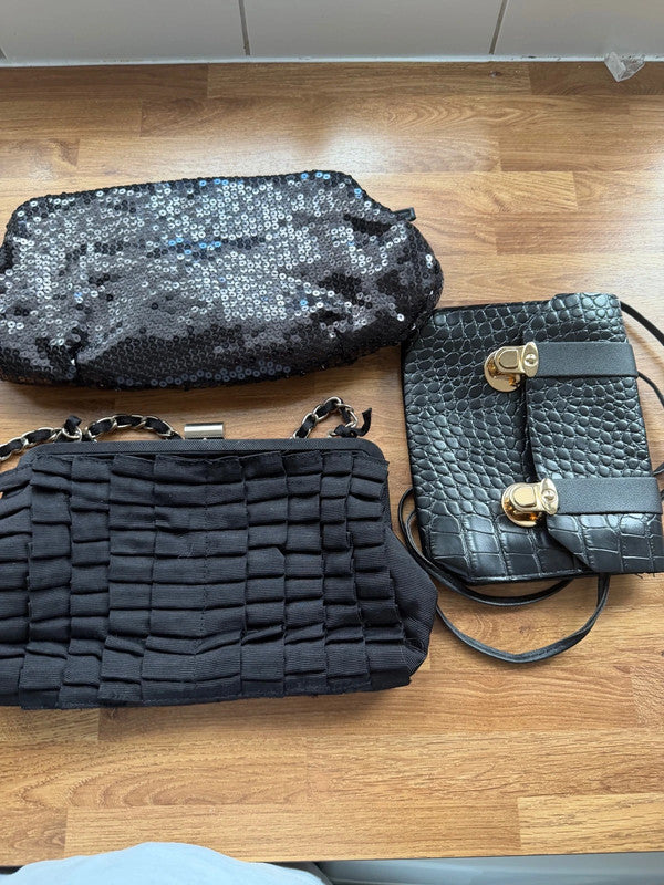Black's black satin evening clutch bag with elegant sheen and shoulder strap.