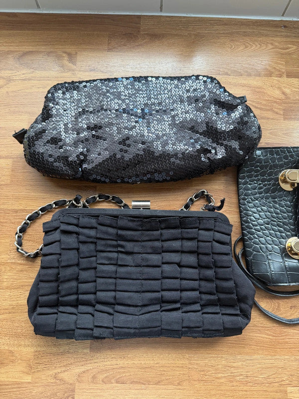 Black's black satin evening clutch bag with elegant sheen and shoulder strap.