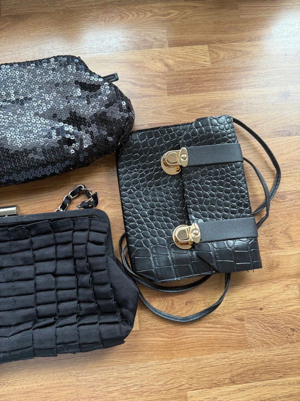 Black's black satin evening clutch bag with elegant sheen and shoulder strap.