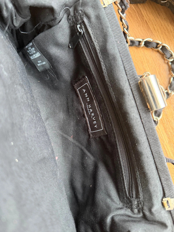 Black's black satin evening clutch bag with elegant sheen and shoulder strap.