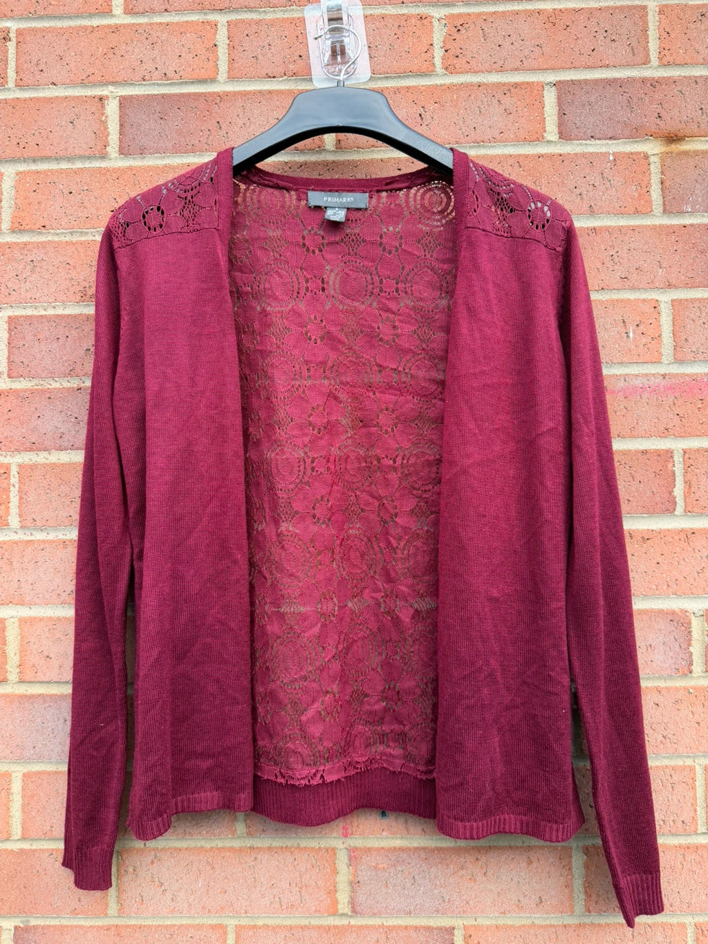 Primark burgundy cardigan with crochet detail and lace back, open front design.