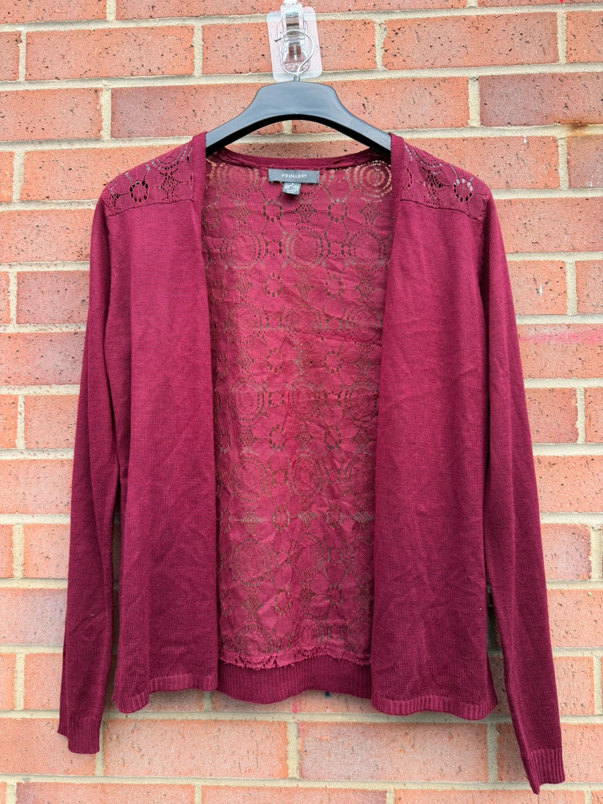 Primark burgundy cardigan with crochet detail and lace back, open front design.