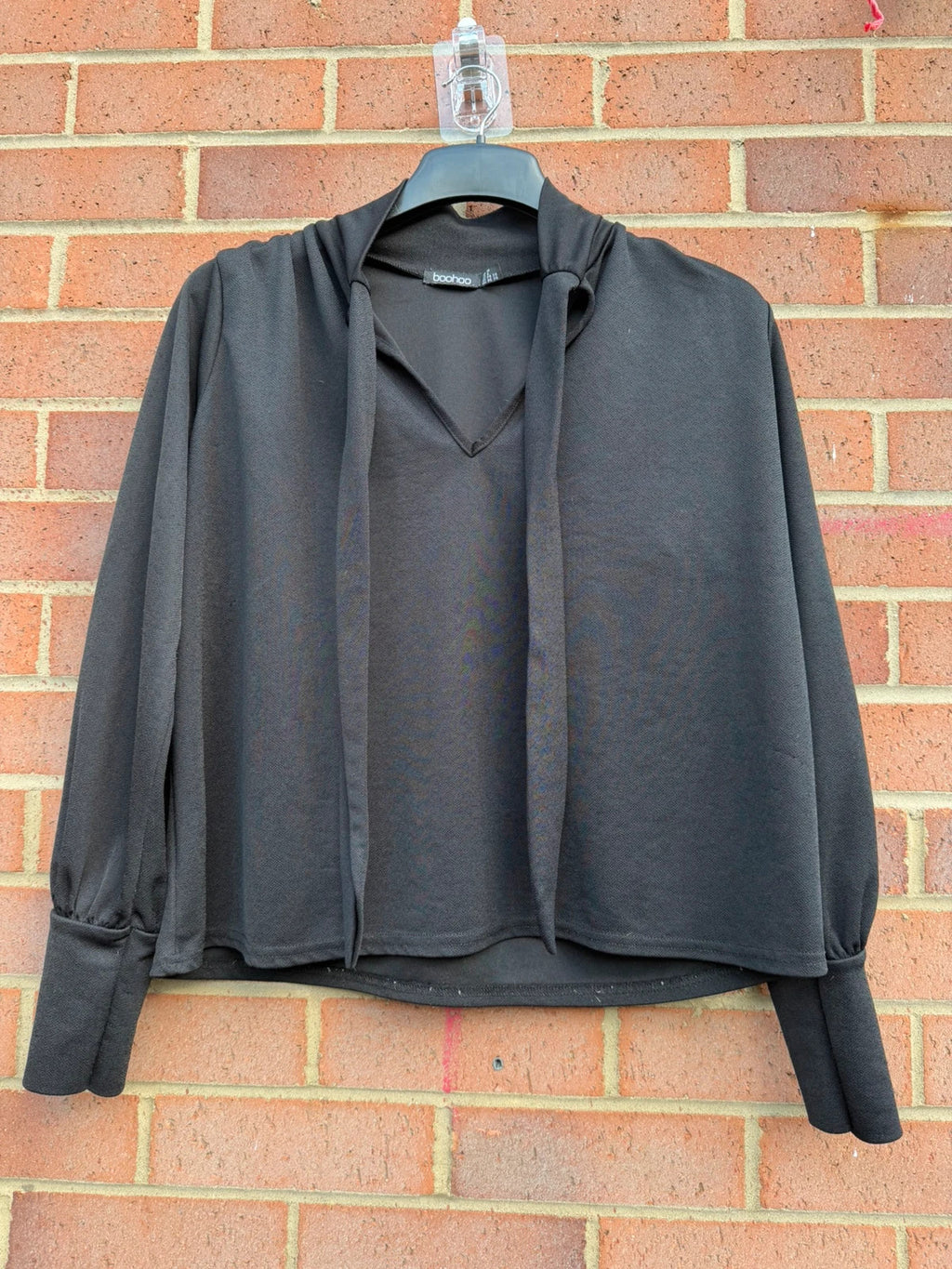 Boohoo black tie neck blouse with long sleeves and elegant office style.