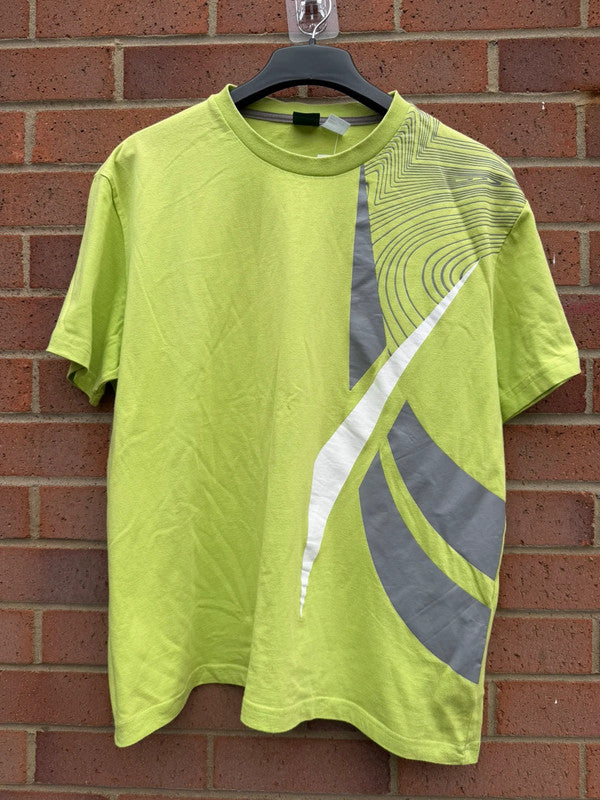 Reebok lime green oversized graphic tee with bold streetwear design and soft fabric.