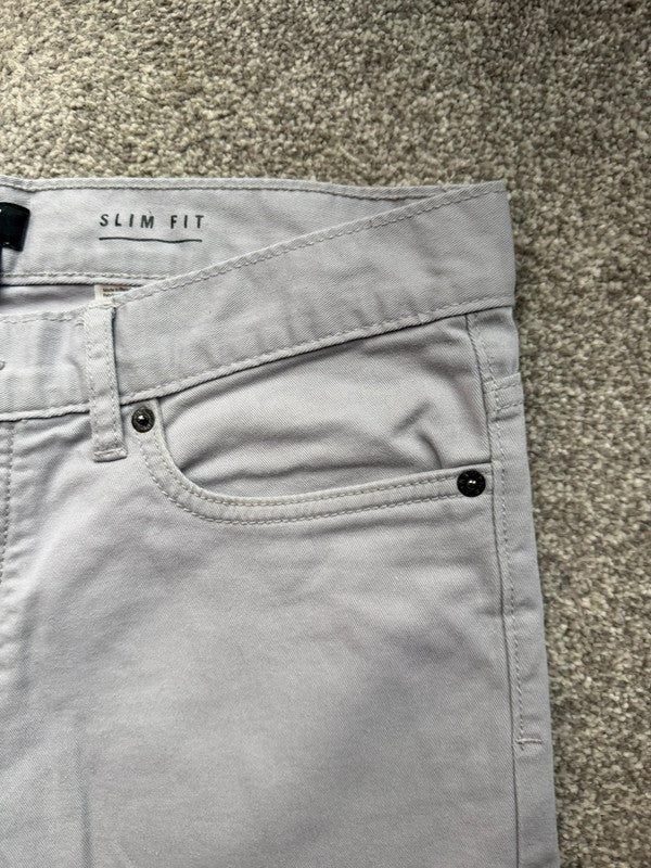 H&M grey chino shorts with stretch fabric and slim fit design.