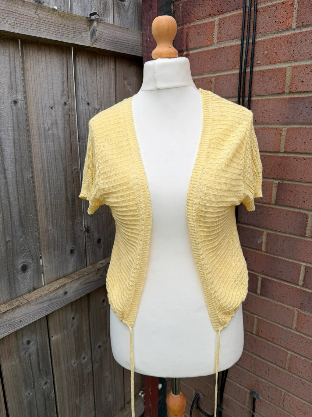 Simply Be yellow knit cropped bolero shrug with tie front detail.